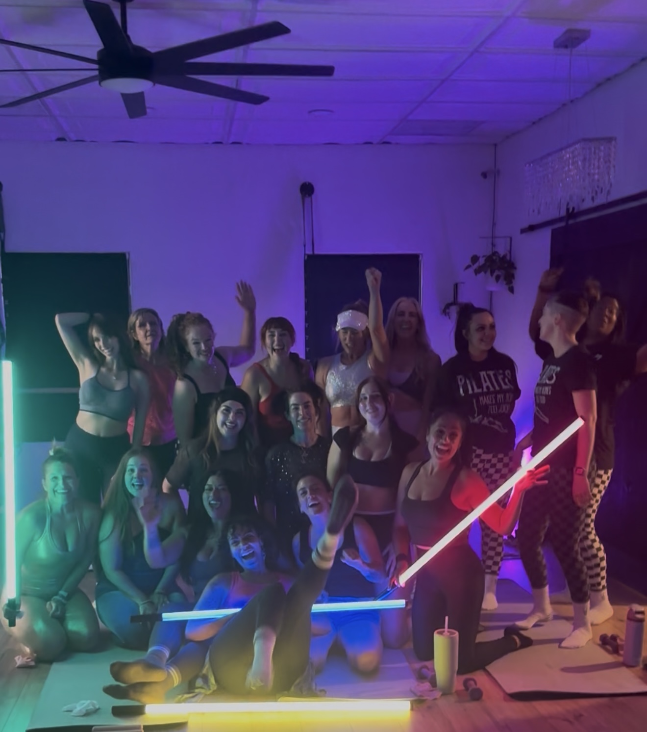 Group celebration after class with neon light tubes